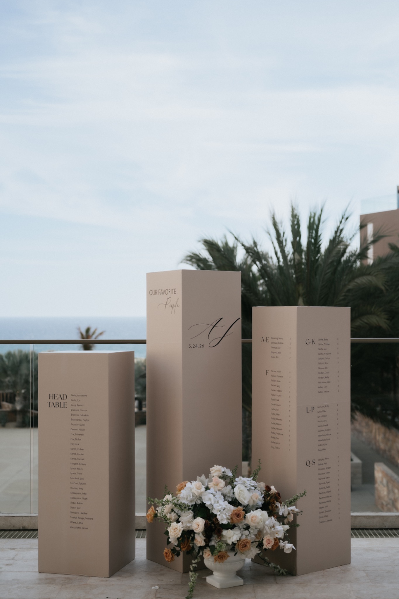 Custom seating chart installation with floral design overlooking the ocean
